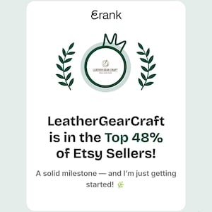 May include: A white card with the text "Erank" at the top, followed by a green circular logo and text that reads "LeatherGearCraft is in the Top 48% of Etsy Sellers!" The bottom text says "A solid milestone - and I'm just getting started!"
