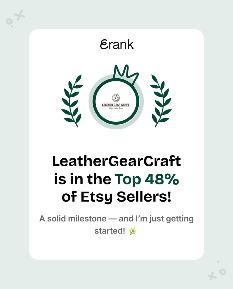 May include: A white card with the text "Erank" at the top, followed by a green circular logo and text that reads "LeatherGearCraft is in the Top 48% of Etsy Sellers!" The bottom text says "A solid milestone - and I'm just getting started!"