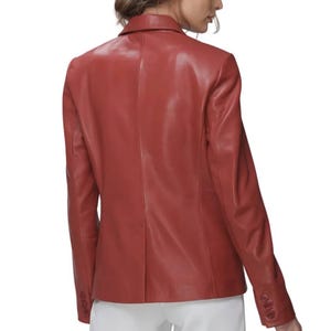 Red Leather Blazer in premium genuine lambskin, featuring a tailored single-breasted notch lapel profile, single button closure, and classic side flap pockets, styled elegantly with high-waisted white trousers.