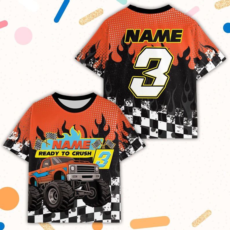 May include: Orange and black graphic t-shirt featuring a monster truck design with the text "READY TO CRUSH" and the number 3. The shirt has a checkered flag pattern and the word "NAME" on the back.