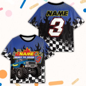May include: Blue and black short-sleeved t-shirt with a monster truck graphic. The shirt features the text "NAME READY TO CRUSH" and the number 3. Flames and a checkered flag design are also present.