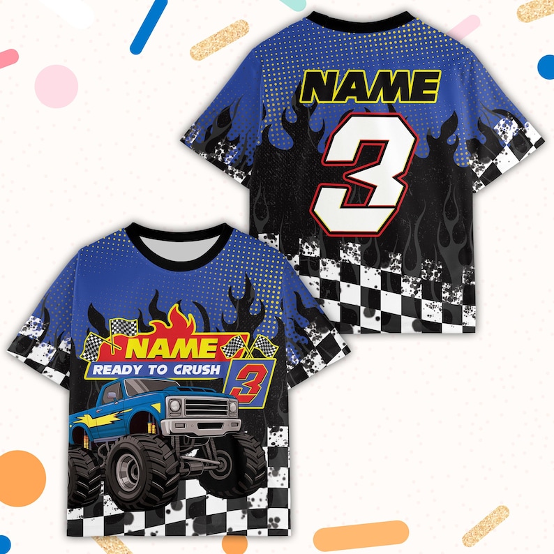 May include: Blue and black short-sleeved t-shirt with a monster truck graphic. The shirt features the text "NAME READY TO CRUSH" and the number 3. Flames and a checkered flag design are also present.