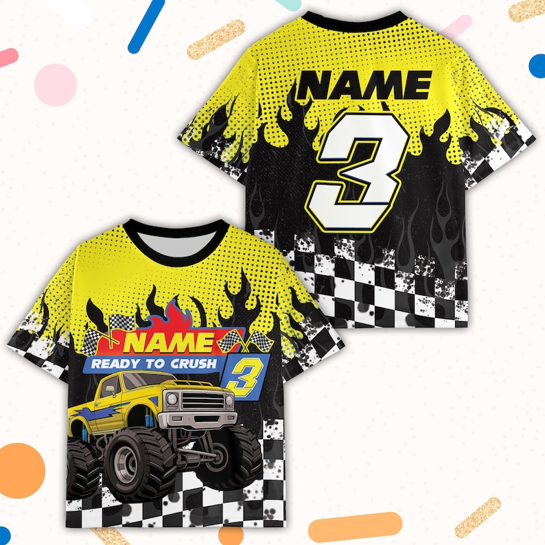 May include: Yellow and black graphic t-shirts with a monster truck design. The shirts feature the word "NAME" and the number "3". One shirt has the text "READY TO CRUSH". The design includes flames and a checkered flag pattern.