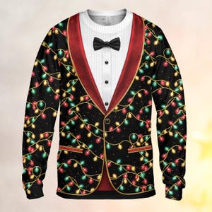 May include: A long-sleeve sweatshirt featuring a printed tuxedo design with a black bowtie, white pinstriped shirt front, and a black jacket pattern decorated with colorful red, green, and yellow Christmas light strings and red lapels.