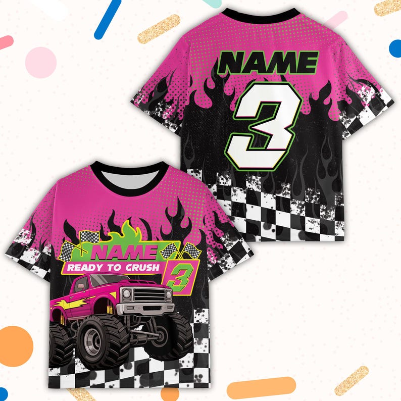 May include: Pink and black short-sleeved t-shirt with a monster truck graphic. The shirt features the text "NAME" and the number "3" in green and white. Flames and a checkered flag design are also present.