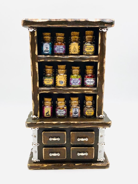 A tiny handcrafted Gothic apothecary cabinet stocked with 12 miniature potion jars — the kind of shelf piece that makes visitors stop and ask 'wait, where did you GET that?'