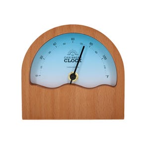 Könnte beinhalten: Ein Holzthermometer mit hellblauem Zifferblatt und geschwungenem Design. Das Zifferblatt zeigt Temperaturmarkierungen von 0 bis 110 Grad Fahrenheit an. Der Text "CARIBBEAN CLOCK THERMOMETER" ist auf dem Zifferblatt aufgedruckt.
