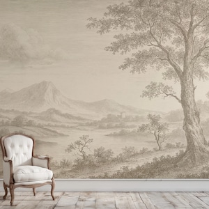 Op de afbeelding: Een sepia-getinte muurschildering met een landschap met bergen, bomen en water. Een wit gestoffeerde fauteuil met een houten frame staat voor de muurschildering. De scène heeft een klassieke, vintage esthetiek.