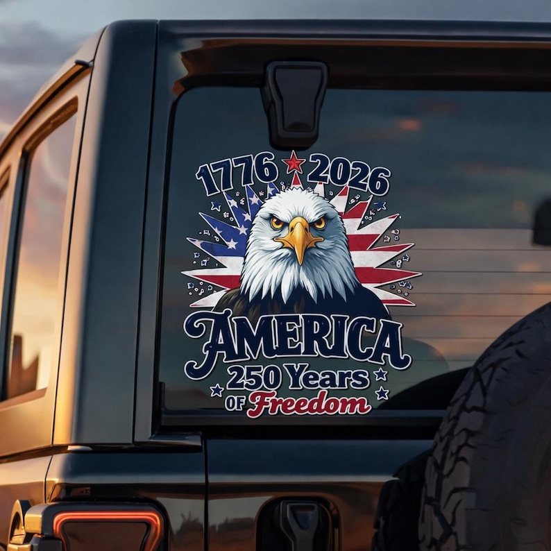 May include: A patriotic decal featuring a detailed illustration of an American bald eagle with a stern expression, set against a backdrop of the American flag. The text reads "1776-2026" and "AMERICA 250 Years of Freedom."
