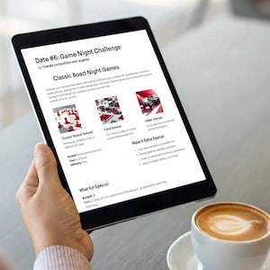 May include: A tablet displays a game night plan with the title "Date #6: Game Night Challenge." The screen shows categories like "Classic Board Games" and "Card Games." A cup of coffee sits on a saucer in the foreground.
