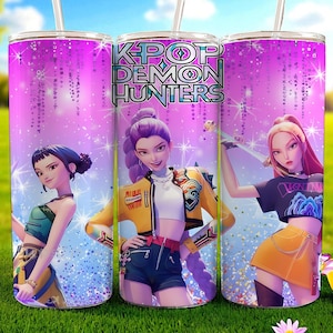 May include: Three stainless steel tumblers with a vibrant design featuring anime-style characters and the text "K-POP DEMON HUNTERS." The tumblers have a pink and purple background with a sparkling effect, and are set against a blurred outdoor backdrop.