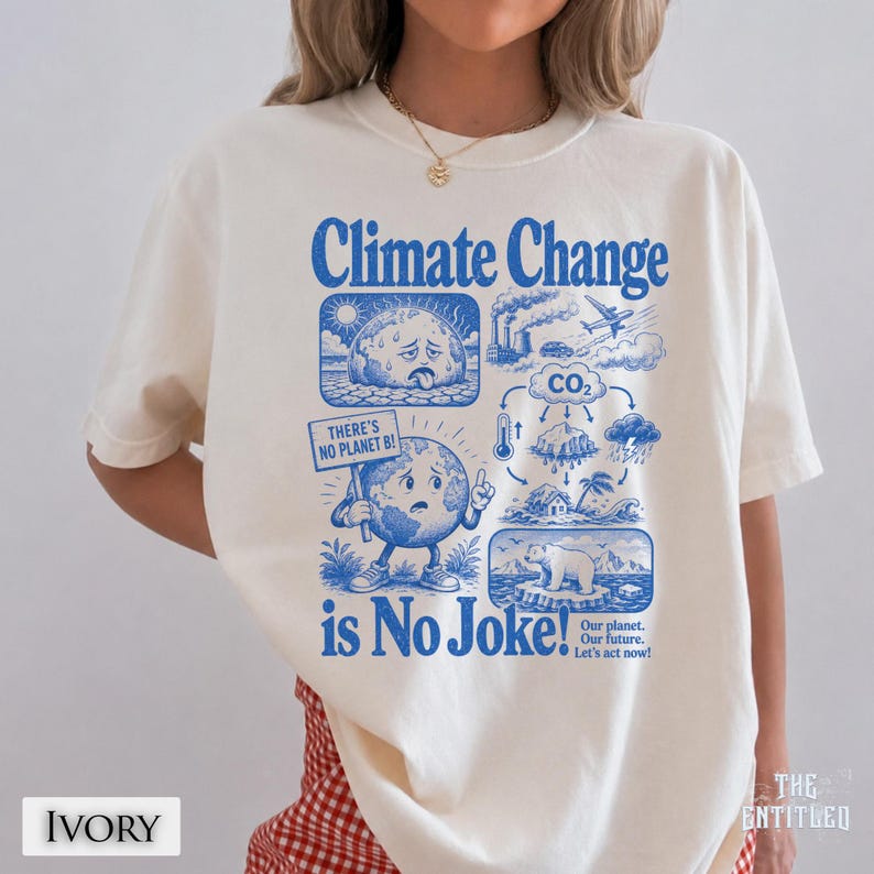 May include: An ivory t-shirt featuring a blue graphic print with the text Climate Change is No Joke! The design includes illustrations of a sweating earth, a thermometer, a polar bear on ice, and a sign that reads There's No Planet B!