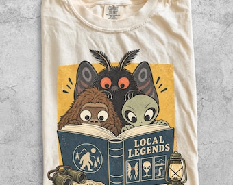 Cute Cryptid Reading Local Legends Shirt, Bigfoot Alien Mothman Tee, Camping Hiking T-Shirt, Funny Spooky Cryptid Lover Gift for Bookworms