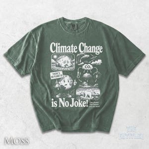 May include: A moss green short-sleeve t-shirt featuring a white graphic print with the text "Climate Change is No Joke!" and "THERE'S NO PLANET B!". The design includes illustrations of a sad earth, a CO2 cycle, and a polar bear on ice.