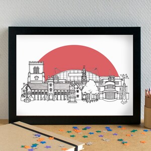 May include: Black and white line drawing of a city skyline with a red sun setting behind it. The skyline includes a church, a stadium, and other buildings.