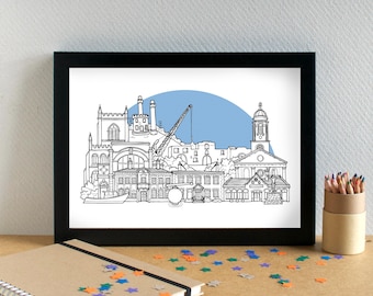 May include: Black framed art print featuring a detailed black and white line drawing of a cityscape with a blue background. The artwork depicts buildings, a crane, and a boat. The print is displayed on a wooden surface with colorful star-shaped confetti.