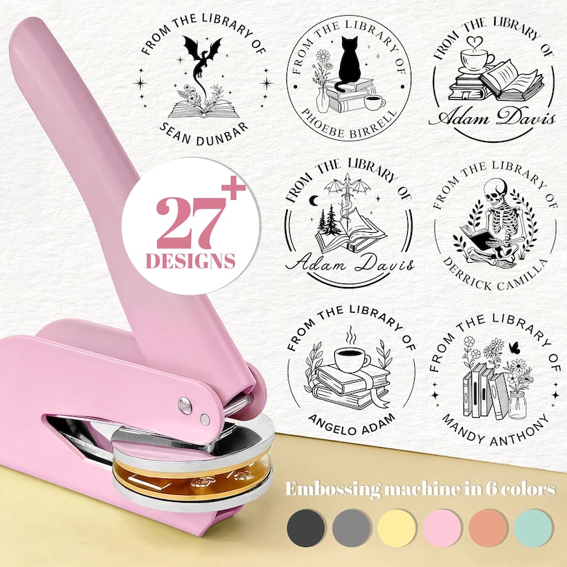 May include: A pink embossing machine with a gold and silver die, surrounded by circular stamp designs. The stamps feature illustrations of books, cats, and other library-themed elements. Text on the image reads "27+ Designs" and "Embossing machine in 6 colors."