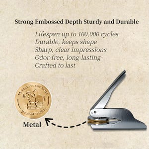 May include: A metal embosser with a gold-colored die and a silver handle. The die features a circular design with text and an illustration of a cat on books. Text on the image reads: "Strong Embossed Depth Sturdy and Durable".