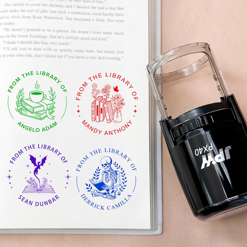 May include: A black self-inking stamp next to a page with four custom library stamps. The stamps feature circular designs with text and illustrations, including books, flowers, and a skeleton reading. The stamp is labeled "PX40".