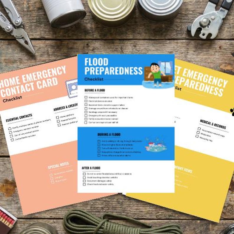 May include: A collection of emergency preparedness checklists and contact cards, including a "Flood Preparedness" checklist with illustrations. The items are arranged on a wooden surface, with tools and canned goods visible in the background.