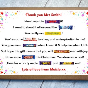 May include: A brown cardboard gift box featuring a white label with colorful star confetti. The label contains a personalized message for a teacher, incorporating various candy bar brand names into the text, signed by Maisie at the bottom.