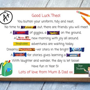 May include: A rectangular cardboard box featuring a printed poem with embedded candy bar names including Flake, Wispa, Twirl, Kinder, Tangfastics, Rolo, Milky Way, Time Out, and Boost. The design includes an A+ symbol, pencils, a backpack, and a chalkboard.