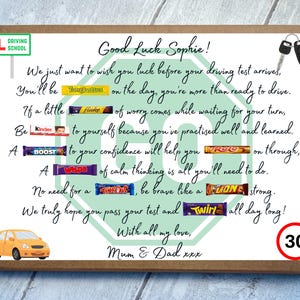 May include: A rectangular cardboard gift box featuring a printed poem for a driving test. The design includes a green octagon, a car key, a yellow car, a speed limit sign, and various candy bars integrated into the text. The text reads Good Luck Sophie, Mum & Dad xxx, and includes references to driving test success.
