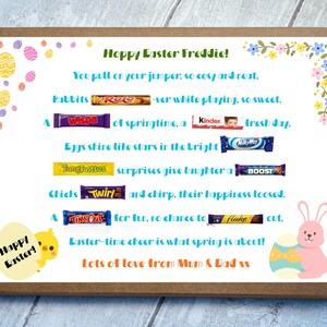 May include: A brown cardboard gift box containing a printed Easter message for Freddie. The card features colorful egg illustrations, a yellow chick, a pink bunny, and various candy bars integrated into the text, including Rolo, Wispa, Kinder, MilkyWay, Tangfastics, Boost, Twirl, TimeOut, and Flake.