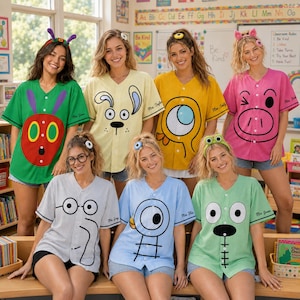 May include: A group of seven people wearing button-down baseball jerseys in various colors, each featuring a unique cartoon character graphic on the front, including a caterpillar, dog, monster, pig, elephant, pigeon, and frog, with matching headbands.