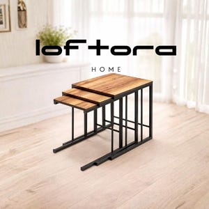 May include: A set of three nesting tables with wooden tops and black metal frames. The tables are arranged in a descending size order, with the largest table at the top. The tables are labeled with the text "loftora HOME".
