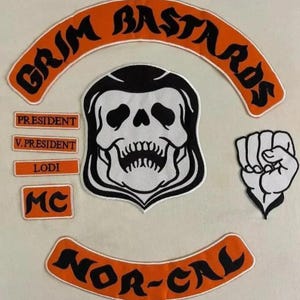 May include: A collection of embroidered patches with a biker theme. The patches include a skull, a clenched fist, and arched patches with the words "GRIM BASTARDS" and "NOR-CAL". Smaller patches read "PRESIDENT", "V.PRESIDENT", "LODI", and "MC".