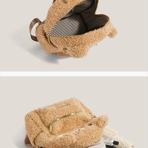 May include: A tan teddy bear backpack with a brown handle and zipper closures. The interior features a striped pattern. The backpack is open, revealing a variety of items inside, including a tablet and a phone.