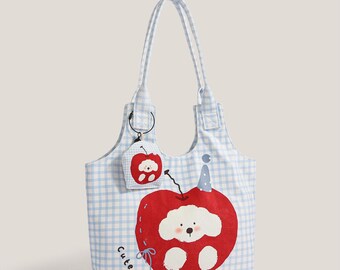 May include: A blue and white gingham tote bag with a large red apple design featuring a cute puppy illustration. The bag has long handles and a matching small pouch. The text "KING STUDIO" and "ALL COLOUR" are visible.