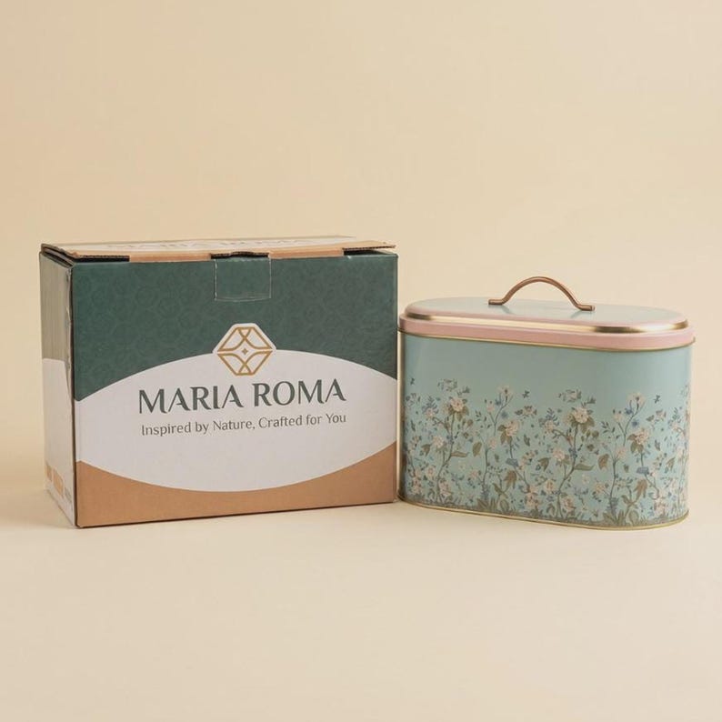 Bread box with gift packaging box from Maria Roma, featuring a large oval vintage botanical floral bread bin with a pink lid and gold handle next to its elegant branded product packaging box, perfect for farmhouse kitchen decor gifts and housewarming presents for home organization.