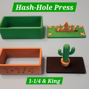 May include: A Hash-Hole Press set featuring two rectangular frames and two base plates. One orange frame is embossed with 1-1/4. One green base plate features a crown and fleur-de-lis, while the black base plate features a green cactus.