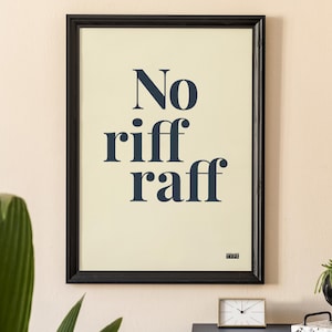 May include: Framed art print with the words "No riff raff" in navy blue on a cream background. The black frame surrounds the print, which is displayed on a wall. A clock and decorative items are on a table below.