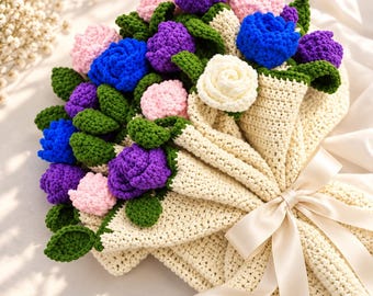 May include: A handmade crochet flower bouquet featuring vibrant blue, purple, and light pink roses with green leaves. The flowers are wrapped in a cream-colored crocheted paper-like sleeve and tied with a smooth, light-colored satin ribbon.