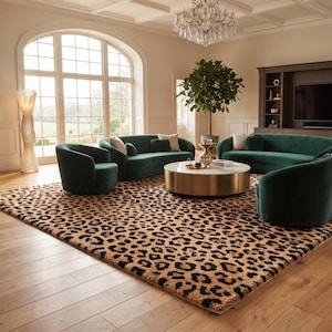 May include: A large rectangular area rug featuring a prominent black and tan leopard print pattern. The rug is positioned under a set of dark green velvet furniture, including two curved sofas and two armchairs, surrounding a round coffee table.