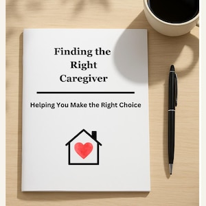 May include: A white book titled "Finding the Right Caregiver" with the subtitle "Helping You Make the Right Choice." The cover features a house icon with a red heart. A black pen and a cup of coffee sit nearby.