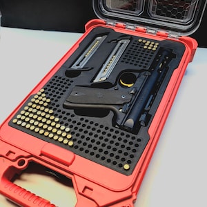 May include: A red, open, hard-shell case with a black interior, containing a black handgun, two magazines, and numerous brass-coloured bullets. The case has a clear top and a handle.