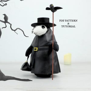 May include: A handmade plush plague doctor doll in black with a white mask and a black hat. The doll holds a staff with a black bird on top and a small black bag. The text "PDF PATTERN & TUTORIAL" is visible.