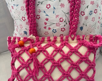 Pink Fuchsia Macrame Bag decorated with two orange wooden ball.