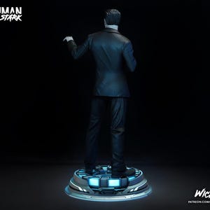Puede incluir: Una figura de Tony Stark de la serie Iron Man, vista desde atr&aacute;s. Viste un traje de raya diplom&aacute;tica y est&aacute; sobre una plataforma futurista con luces azules. Las palabras "Ironman Tony Stark" est&aacute;n en la parte superior izquierda.