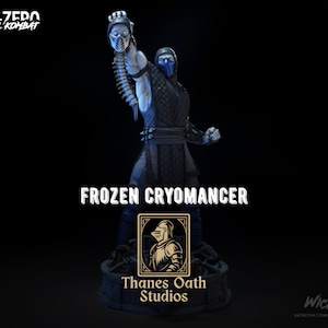 May include: A detailed statue of a character from the Mortal Kombat video game series. The figure is predominantly blue and black, holding a mask. The base features the text "FROZEN CRYOMANCER" and "Thanes Oath Studios".