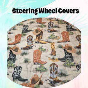 May include: Steering wheel cover with a beige background featuring a pattern of cowboy boots and hats in various colors. The boots are brown, black, and tan, and the hats are brown. The text "Steering Wheel Covers" is at the top.