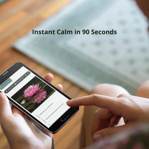 May include: A black smartphone displays a pink water lily image with the text "Instant Calm in 90 Seconds." The screen shows audio controls and instructions. The phone is held by a person.