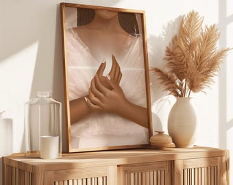 May include: A framed art print featuring a digital illustration of two hands clasped together. The artwork has a warm color palette with a focus on the hands and a soft, ethereal background. The print is displayed on a wooden cabinet with decorative items.