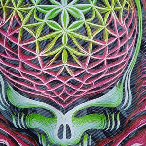 May include: Close-up of a colorful, stylized skull design. The artwork features a geometric pattern in shades of green, pink, and white, set against a denim-like background. The skull's features are outlined in white and green.