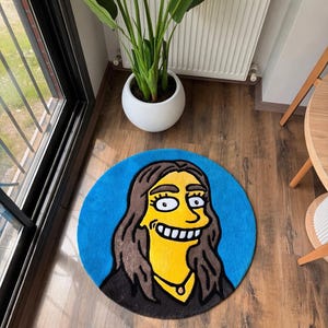 May include: A round, blue rug featuring a cartoon character with yellow skin, brown hair, and a black outfit. The rug is placed on a wooden floor, with a white potted plant and a window in the background.