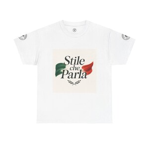 May include: White t-shirt with the Italian phrase "Stile che Parla" and an Italian flag design in green, white, and red. The design includes a stylized flag and a sprig of leaves. The shirt has a crew neck and short sleeves.